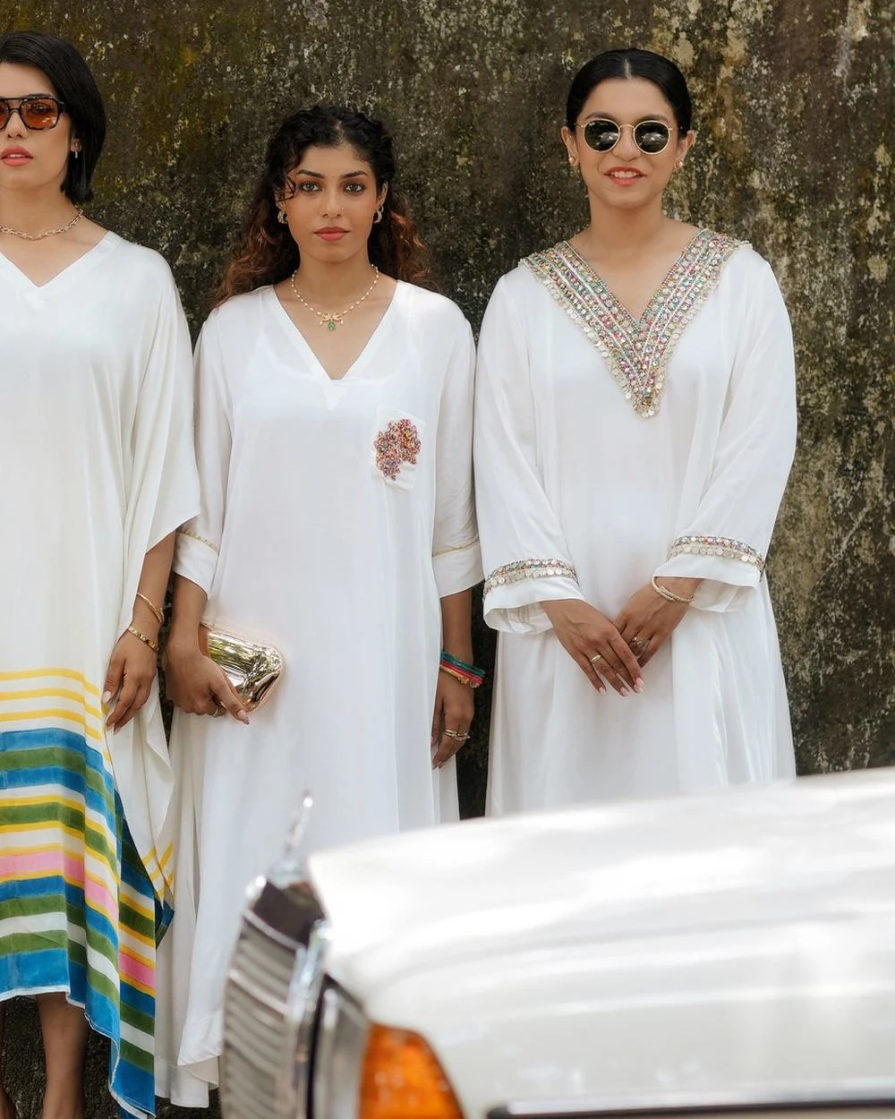 Women in ivory kaftans in an old Kochi lane