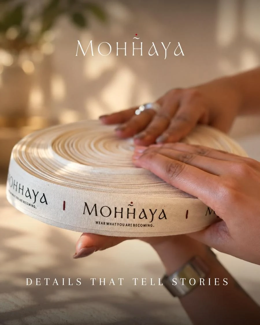 A roll of Mohhaya labels held in two hands